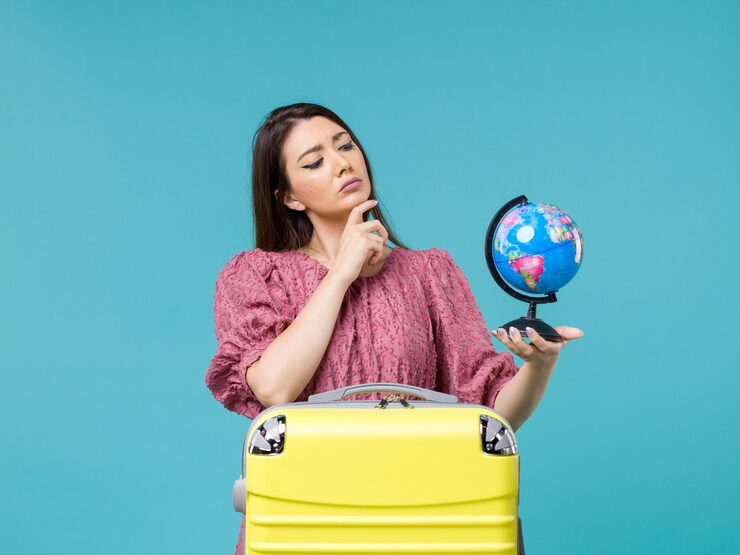 front view female vacation holding little earth globe blue background sea vacation journey summer woman trip 140725 89336